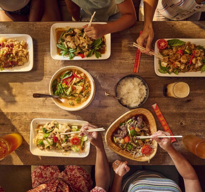 food dishes on the table and people sharing