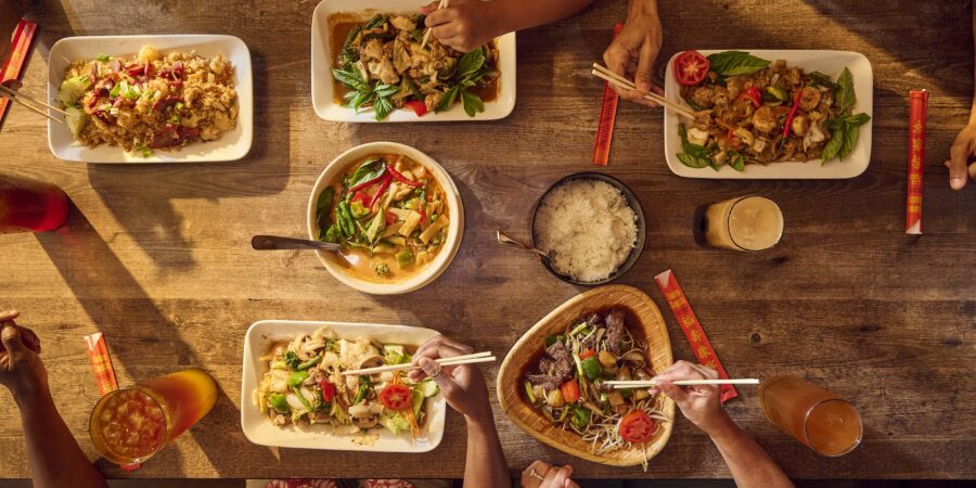 food dishes on the table and people sharing