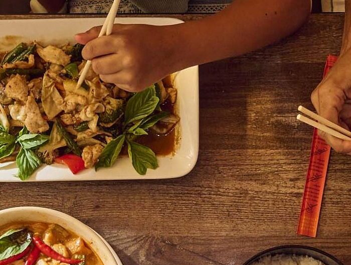 food dishes on the table and people sharing